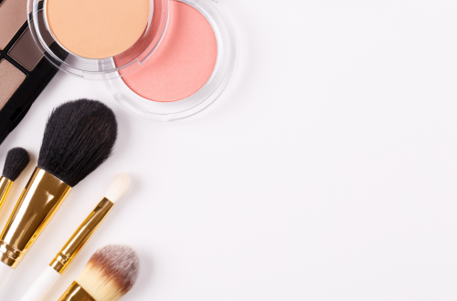 Makeup brushes and makeup on a white background