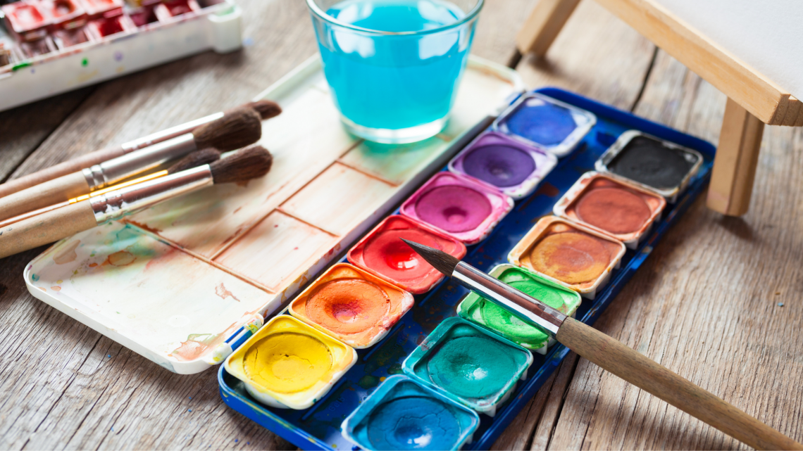 Photo of watercolor paint palette and brushes