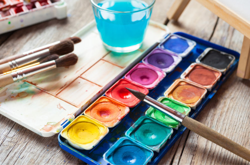 Photo of watercolor paint palette and brushes