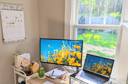 Home office with motivational sticker chart on the wall.